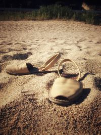 Close-up of sunglasses on sand