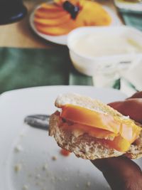 Close-up of hand holding burger