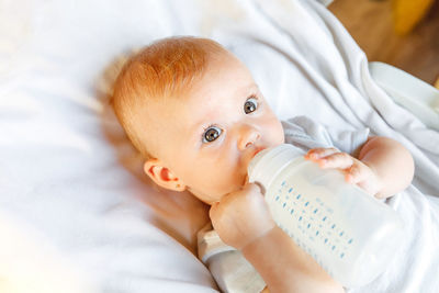 Portrait of cute baby boy sleeping on bed