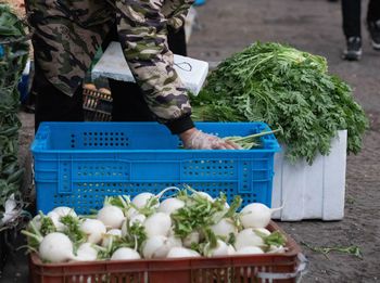 Rear view of man with vegetables for sale
