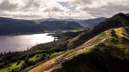 High angle view of sea and mountains against sky