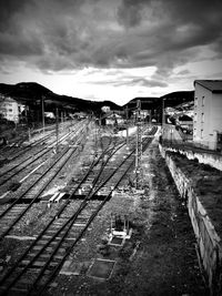 Railroad tracks by buildings against sky
