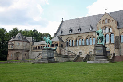 Lawn by building against sky