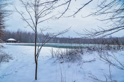 Scenic view of frozen lake against sky during winter