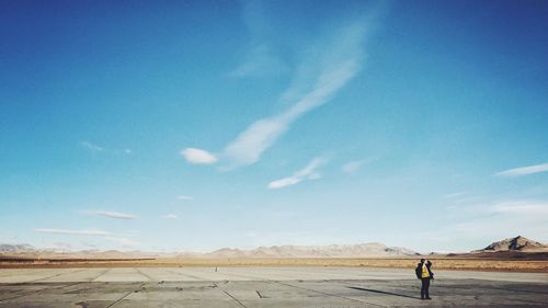 Man standing on road against sky