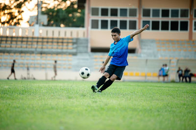 Man playing soccer ball on field