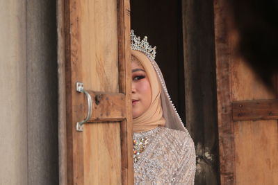 Portrait of woman looking away at entrance