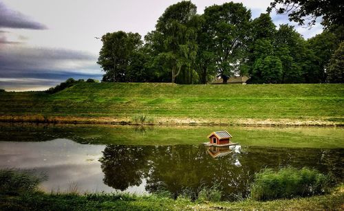 Reflection of man in lake against sky