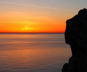 Scenic view of sea against romantic sky at sunset