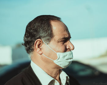 Close-up portrait of man wearing a mask