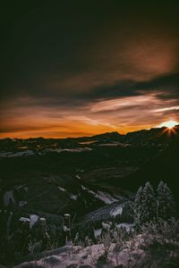 Scenic view of landscape against sky at sunset