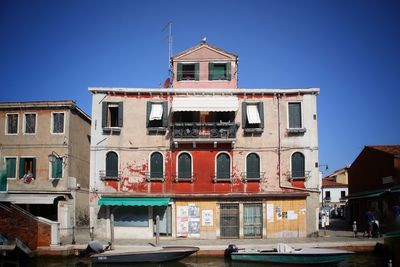 View of residential buildings against clear blue sky
