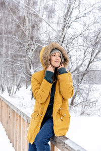 Full length of woman standing in snow