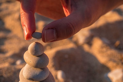 Close-up of human hand on rock