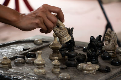 Low angle view of man playing on chess board