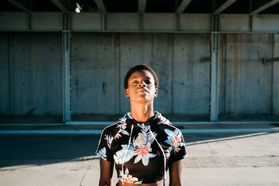 Portrait of man standing against wall