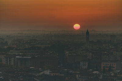 High angle view of buildings in city during sunset