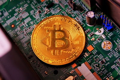 High angle view of bitcoin on circuit board