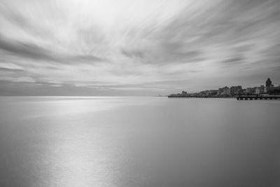 Scenic view of sea against sky in city