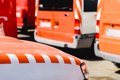 Close-up of orange car on street