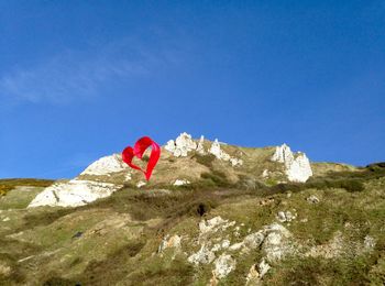 Low angle view of mountain against blue sky