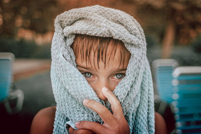 Close-up portrait of boy in beach towel