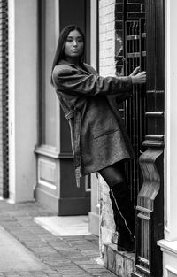 Woman standing by window