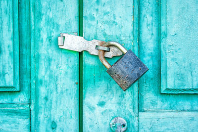 Close-up of latch on wooden blue door