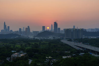 Cityscape against sky during sunset