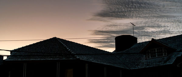 Low angle view of silhouette building against sky