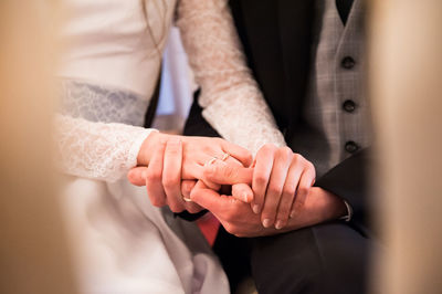 Extreme close up of couple holding hands