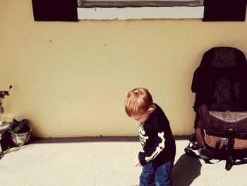 Boy standing by horse