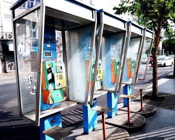 Chairs on sidewalk in city