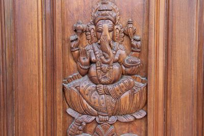 Close-up of sculpture on wooden door