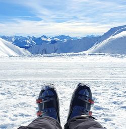 Low section of people on snowcapped mountains during winter