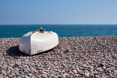 Pebbles on beach against sky