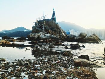 View of rocks on land against sky