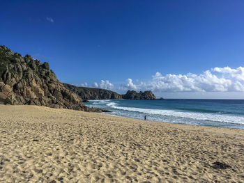Scenic view of beach against blue sky