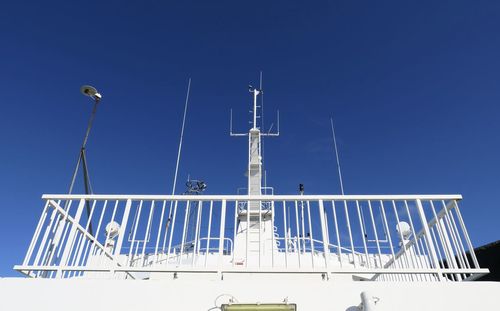 Low angle view of sailboat against clear blue sky