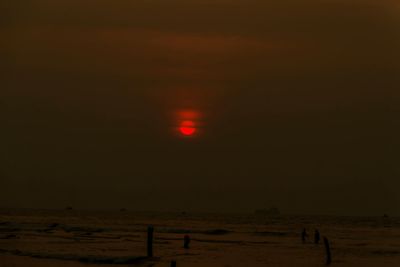 Scenic view of beach against sky during sunset