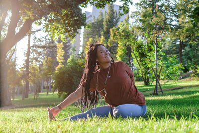 Beautiful young woman is doing yoga outside in a park. concept of healthy lifestyle.