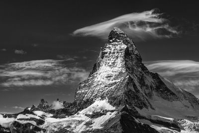 Low angle view of snowcapped mountain against sky