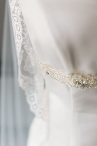 Close-up of wedding rings against white wall