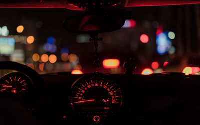 Close-up of illuminated car speedometer