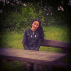 Woman sitting on bench in park