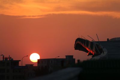 Bridge under constructing against sky during sunset