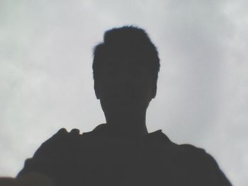 Rear view of silhouette man against sky