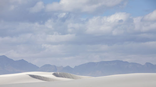 Scenic view of mountains against cloudy sky