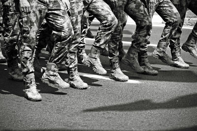 Soldiers marching on street in city