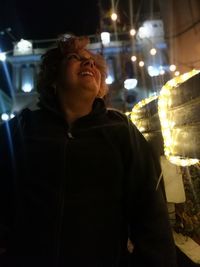 Man looking at illuminated restaurant